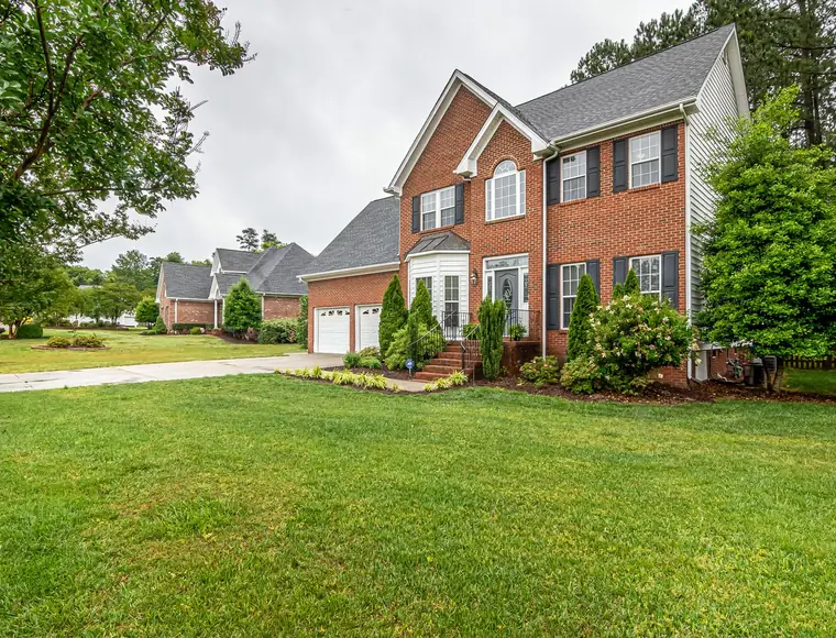 Home with newly installed landscaping and mulched beds